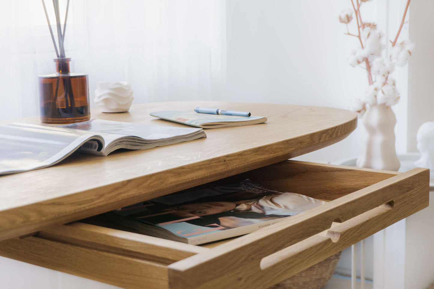Kunsst solid wood desk for home office can be used as wooden office desk, wooden desk with drawers for makeup or even desk in bedroom with drawer under desk or solid oak desk for home office. Oak wooden desk standing  floor in front of big window. Detail view of drawer.