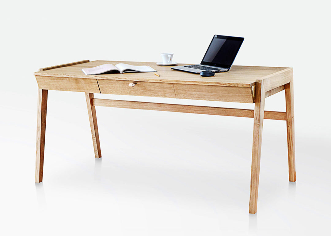 The KUNSST FURNITURE Solid Oak Desk with Drawer - Model_No.01 is set against a plain white background, highlighting its traditional woodworking craftsmanship. On the desk's surface, an open book, a cup, and a laptop evoke a sense of productivity and tranquility.