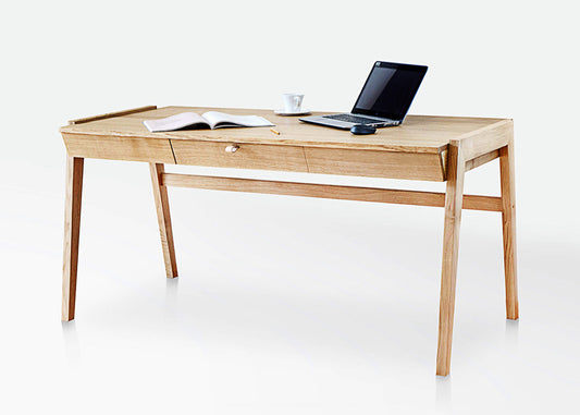 The KUNSST FURNITURE Solid Oak Desk with Drawer - Model_No.01 is set against a plain white background, highlighting its traditional woodworking craftsmanship. On the desk's surface, an open book, a cup, and a laptop evoke a sense of productivity and tranquility.