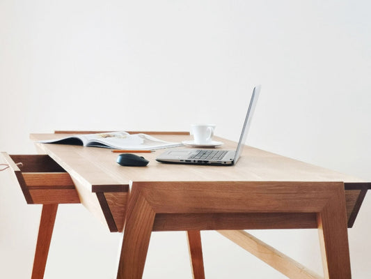 Scandinavian style solid oak desk with drawer side view on white background