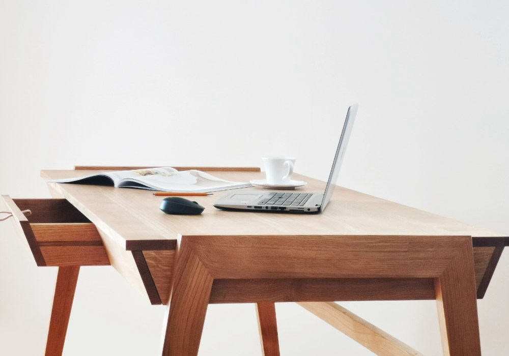 Scandinavian style solid oak desk with drawer side view on white background