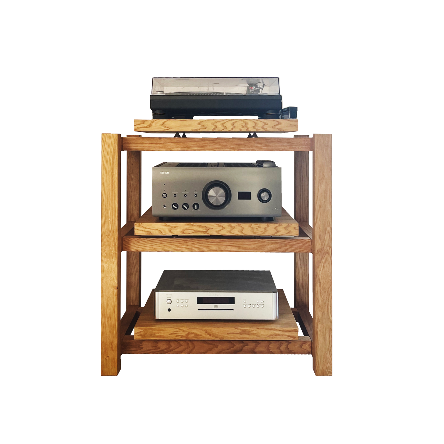 The KUNSST FURNITURE Hi Fi Audio Rack is a wooden stand that elegantly holds three hi-fi electronic devices: a turntable on the top shelf, an audio receiver in the middle, and a CD player on the bottom shelf. These high-end devices are neatly organized on each level.