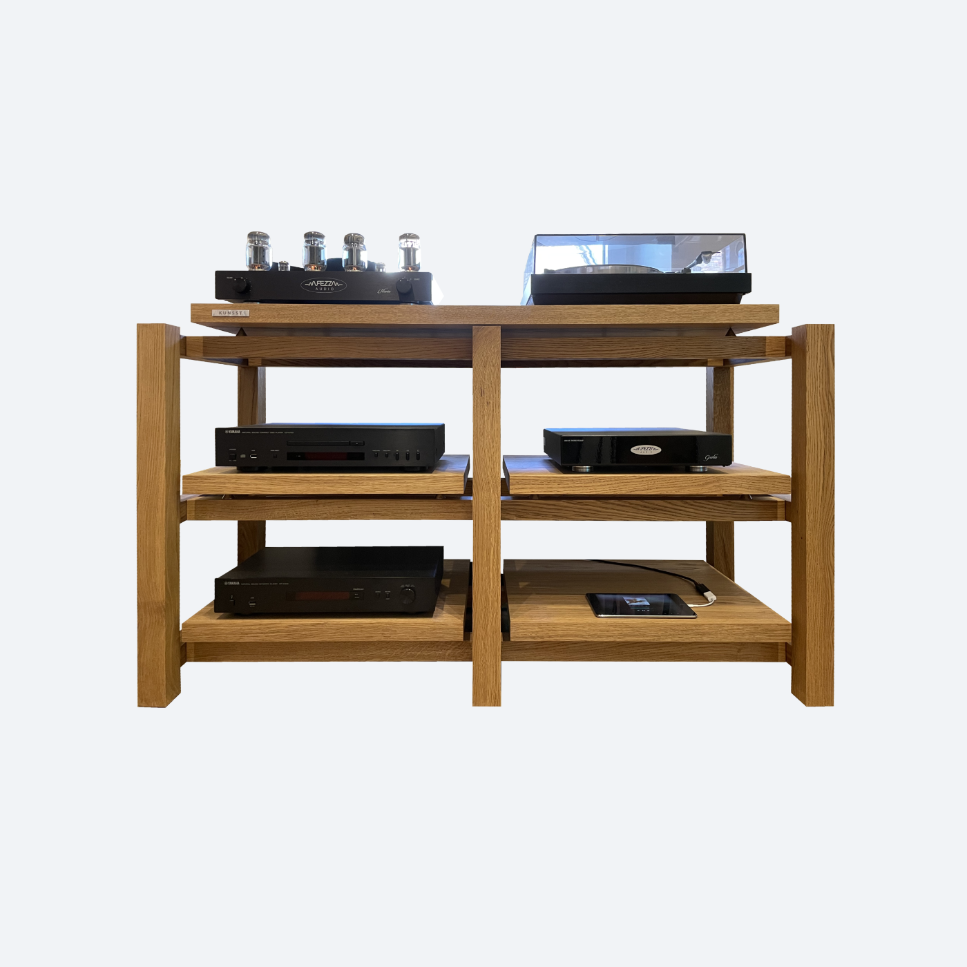 KUNSST FURNITURE's Hi Fi Audio Rack features a vintage amplifier and turntable on top, highlighting exceptional hi-fi precision. The shelves accommodate various audio equipment such as CD players and a record player, all set against a plain background. This high-end setup is ideal for audiophiles who value both aesthetics and sound excellence.