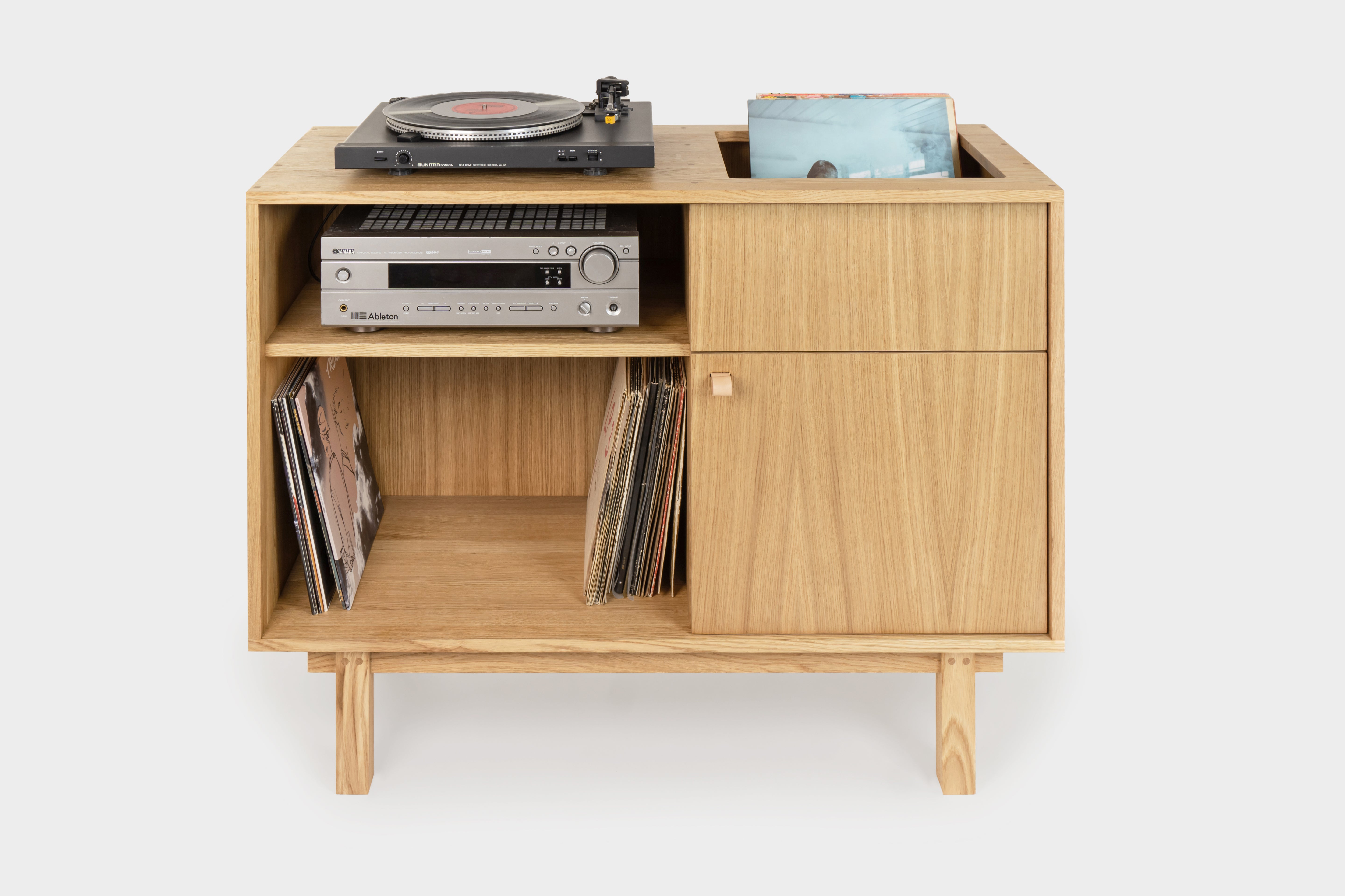 A solid oak vinyl record cabinet with a turntable on top and a small shelf with amplifier
