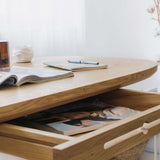 Kunsst solid wood desk for home office can be used as wooden office desk, wooden desk with drawers for makeup or even desk in bedroom with drawer under desk or solid oak desk for home office. Oak wooden desk standing  floor in front of big window. Detail view of drawer. 