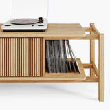 Close-up of the fluted oak front panel on a vinyl record storage cabinet 