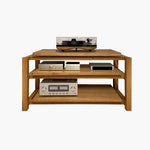 Kunsst holz hifi rack, ausgestattet mit drei Antivibrationsplattform, mit einem Plattenspieler auf der obersten Plattform, einem Verstärker und einem DAC auf der untersten und einem kleinen rechteckigen HiFi-Gerät, steht auf einem weißen, neutralen Hintergrund.