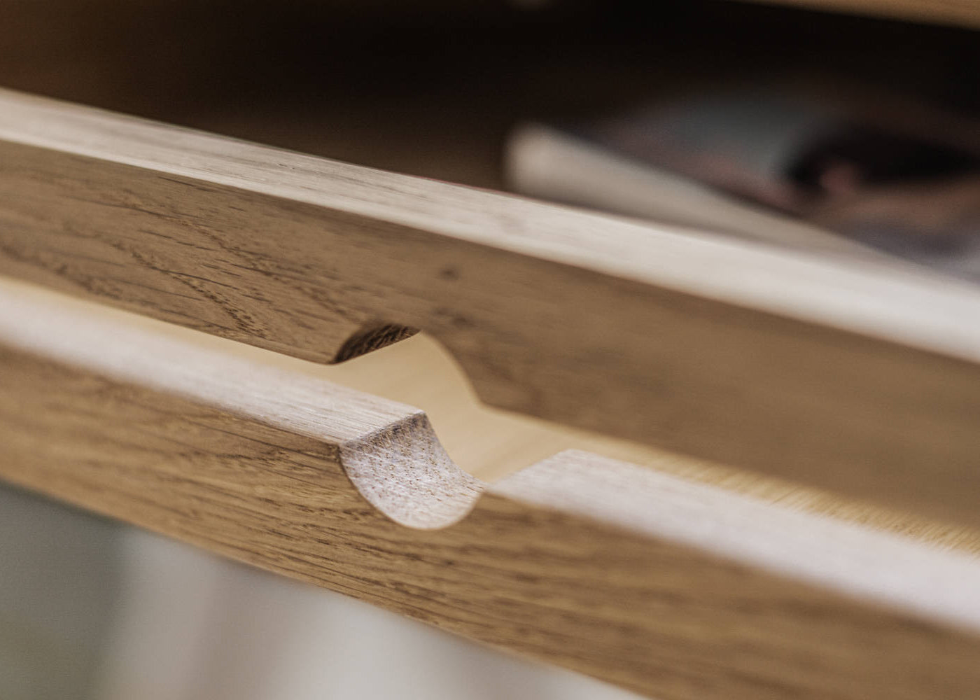 Close-up of a  wooden drawer of white oak secretary desk with a smooth finish 