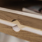 Close-up of a  wooden drawer of white oak secretary desk with a smooth finish 