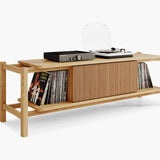 Turntable and amplifier standing on big wooden audio cabinet with vinyl records storage shelf 