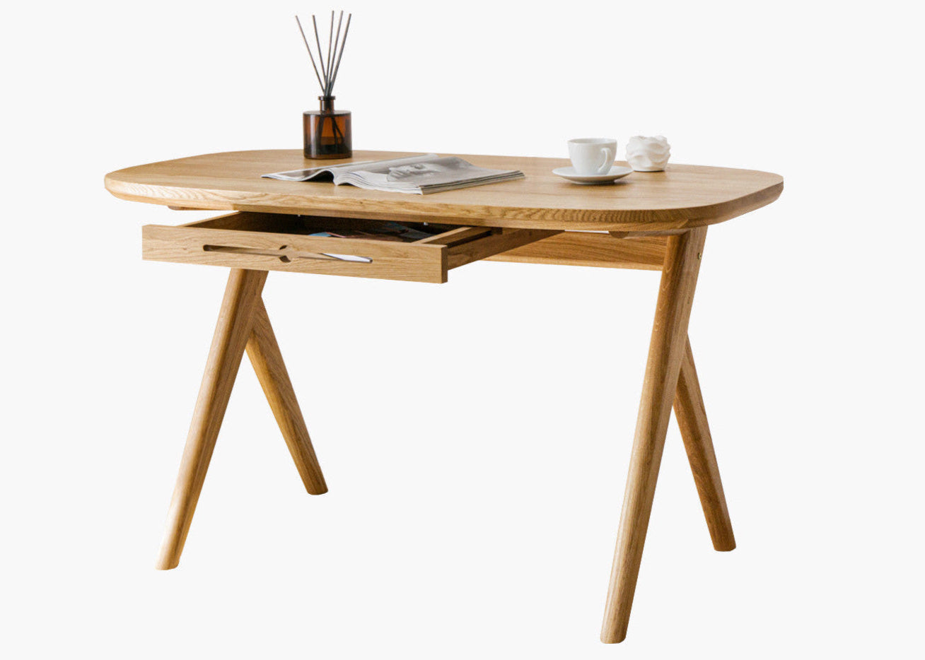 Designer solid wood desk for small spaces  with  magazine and two cups on oak desk top standing on white background