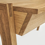 Close-up of a wooden desk with drawer with visible oak grain and joint details on a white background 