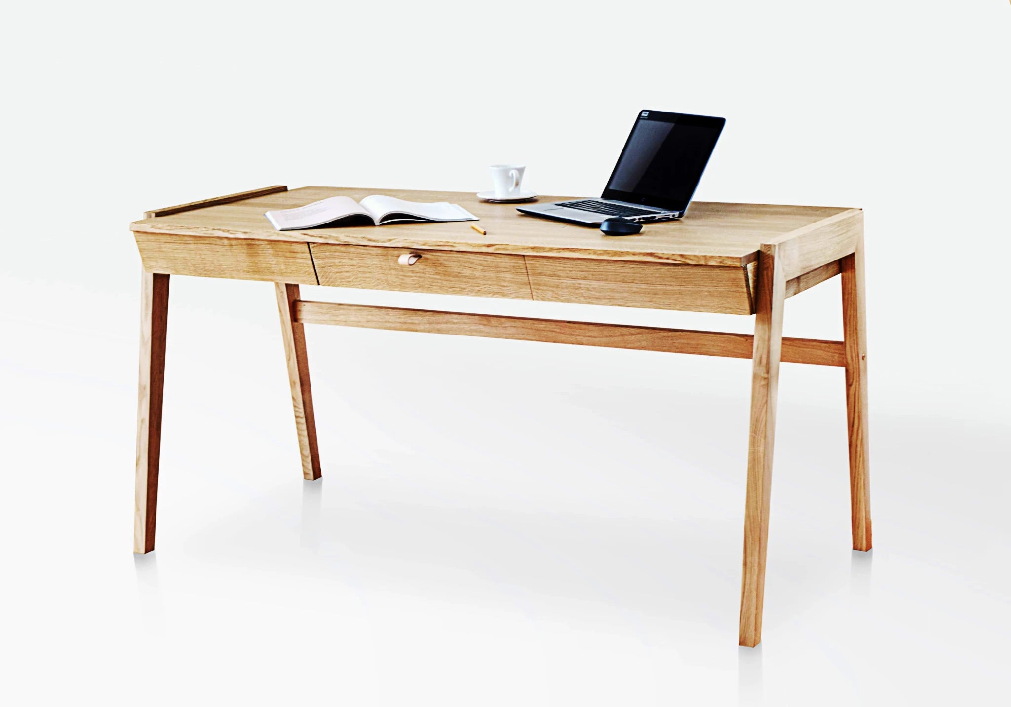 Solid wood desk with drawers in handmade oak, premium home office furniture with a laptop and open book on a white background